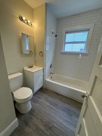 a bathroom with a toilet a sink and bathtub