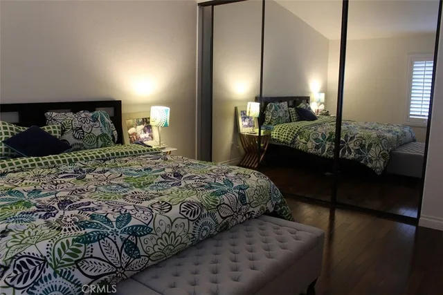 a bedroom with a bed mirror and window