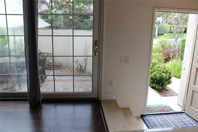 a view of a porch with wooden floor and a gate