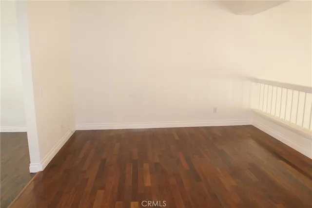 an empty room with wooden floor