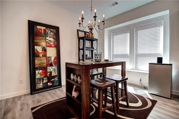 a dining room with furniture and window