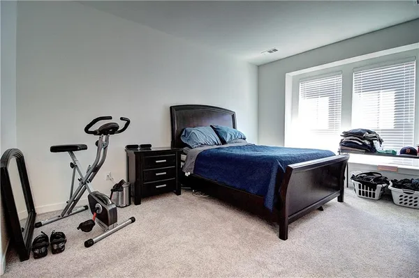 a bedroom with a bed a desk and chair