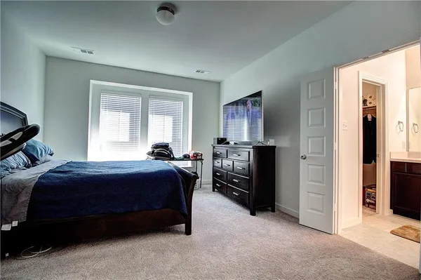 a bedroom with a bed and a dresser