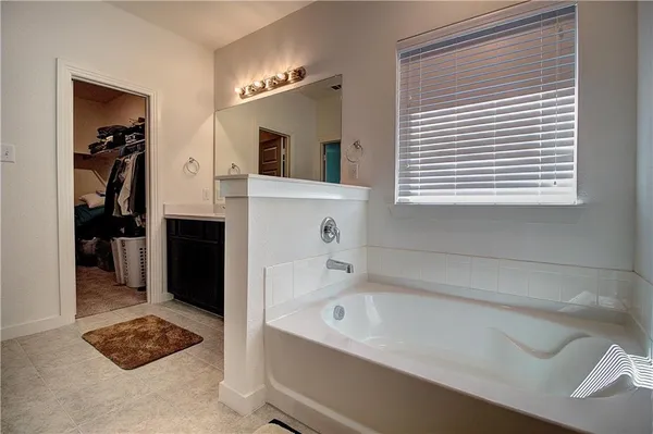 a bathroom with a bathtub and a window