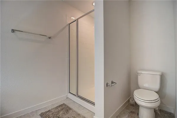 a bathroom with a shower and a toilet