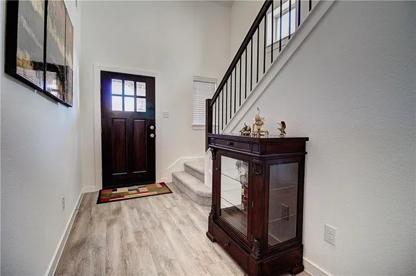 a view of entryway with wooden floor and stairs