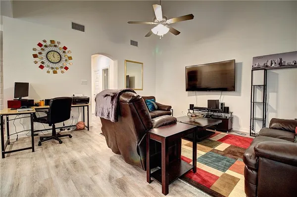 a view of a workspace with furniture and a flat screen tv
