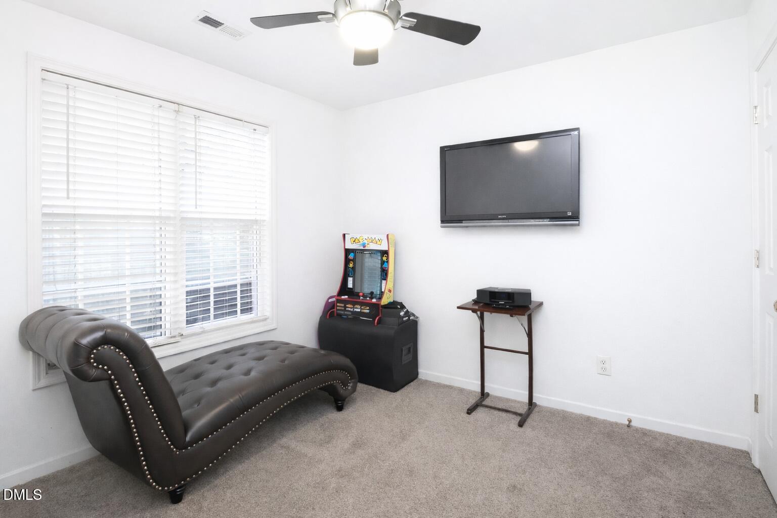 1504 Springshire Court Raleigh, NC 27610 - Photo 10 of 16 a living room with furniture and a flat screen tv