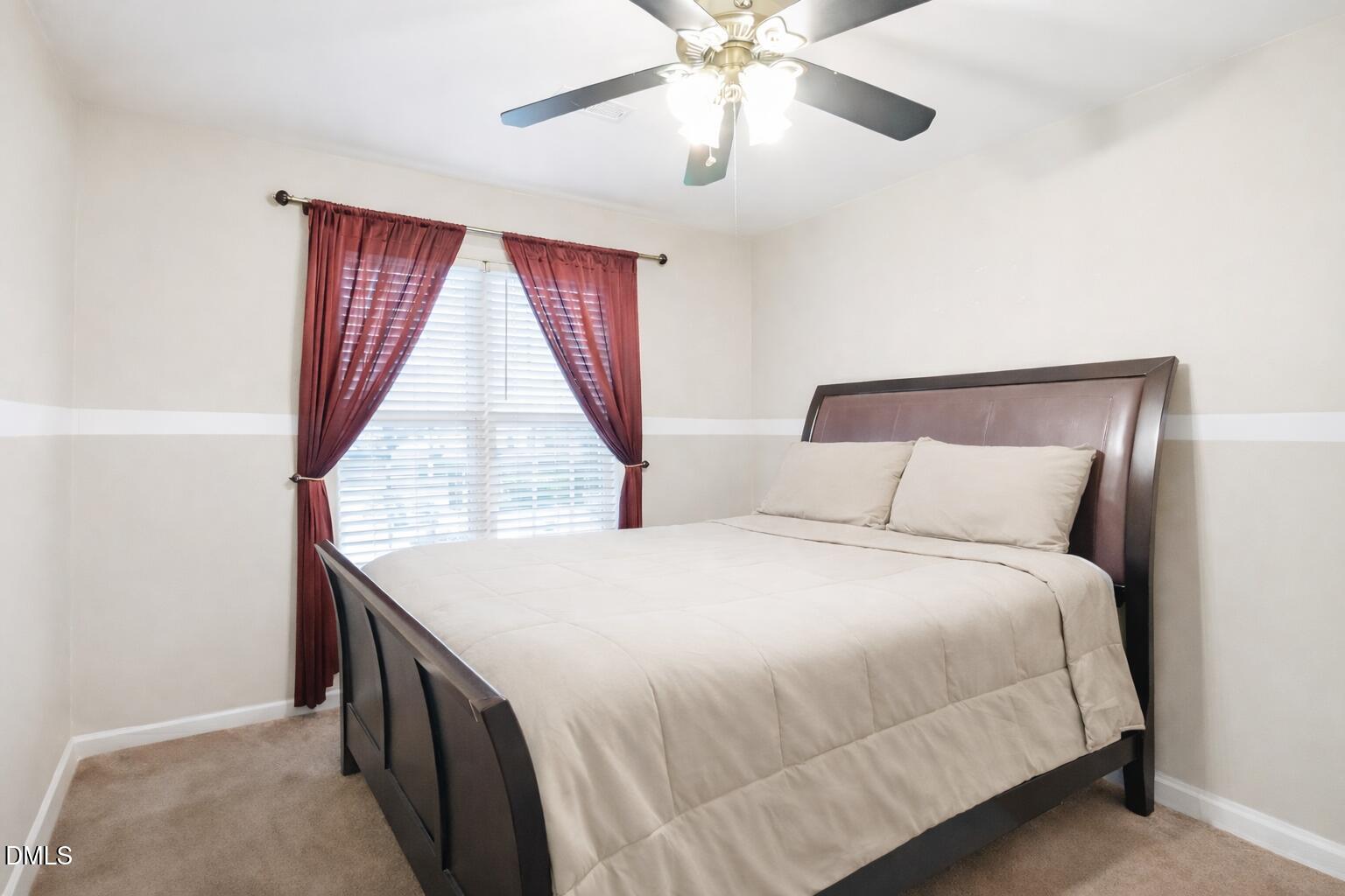 1504 Springshire Court Raleigh, NC 27610 - Photo 11 of 16 a spacious bedroom with a bed and a chandelier