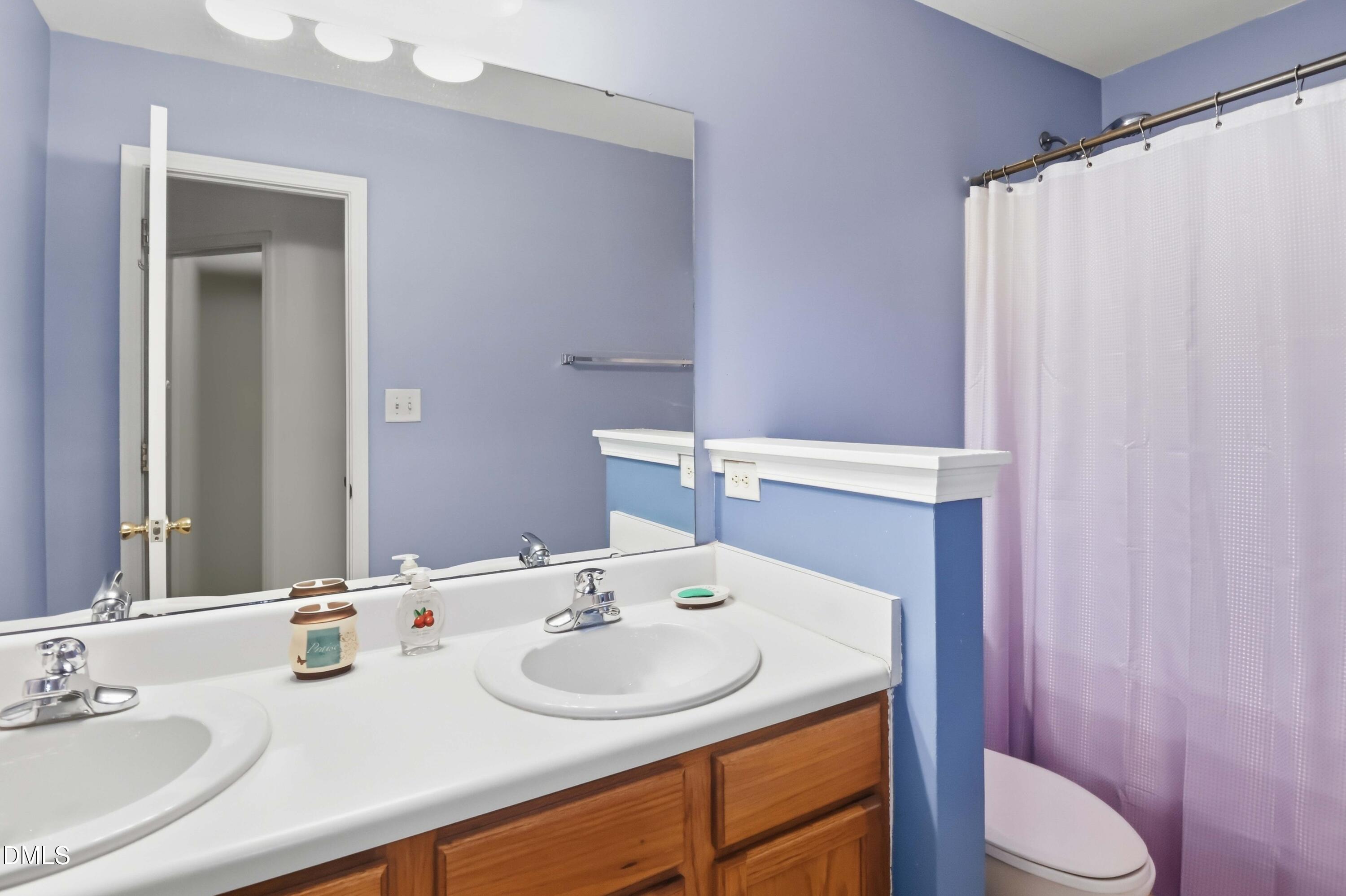 1504 Springshire Court Raleigh, NC 27610 - Photo 12 of 16 a bathroom with a sink toilet and shower