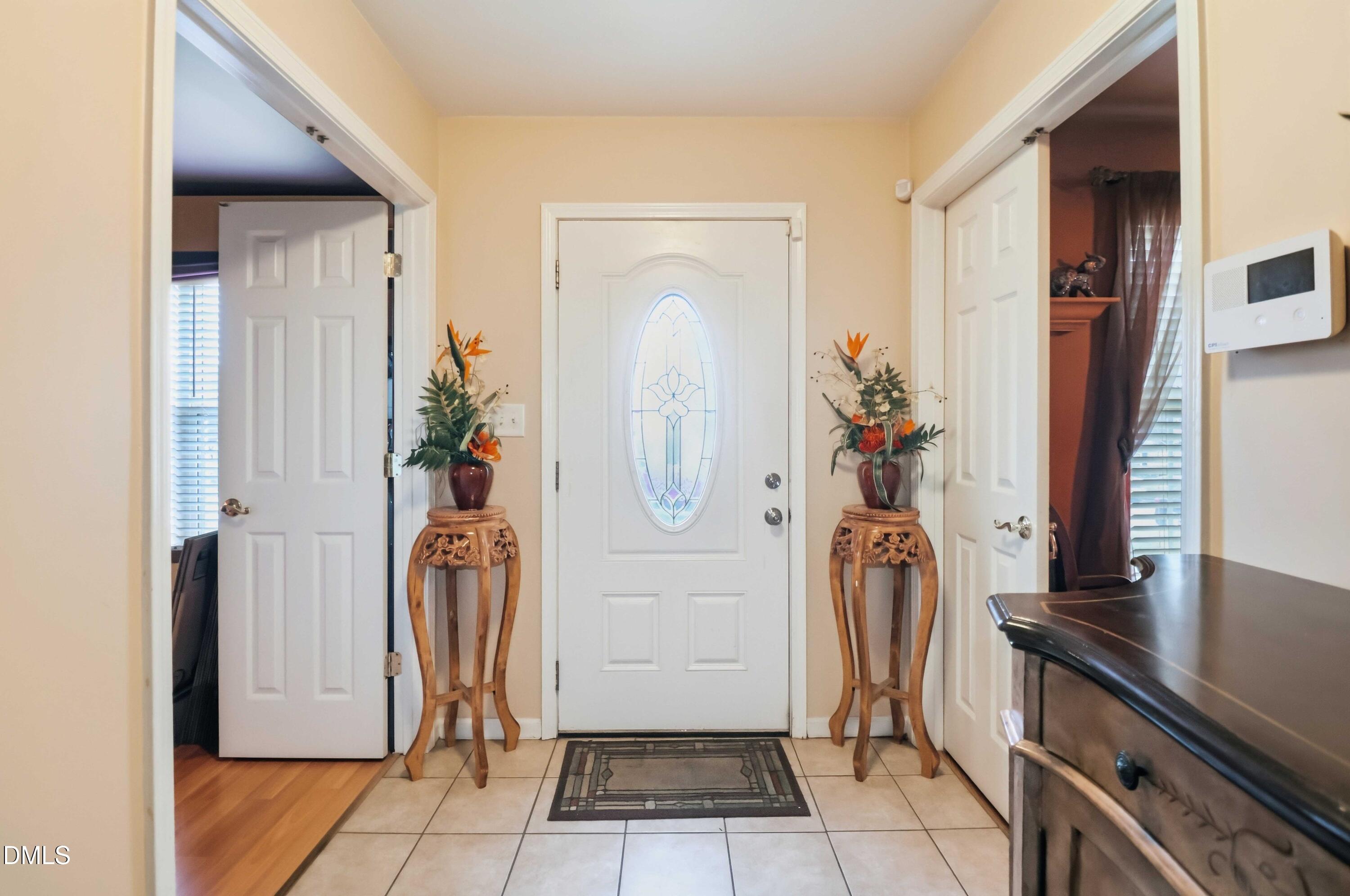 1504 Springshire Court Raleigh, NC 27610 - Photo 2 of 16 a view of hallway with wooden floor and stairs
