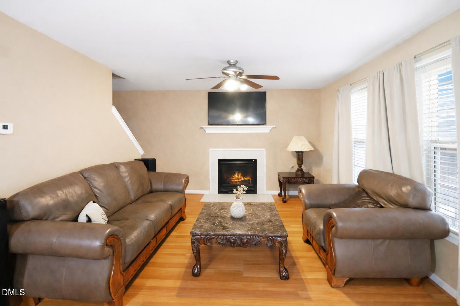 1504 Springshire Court Raleigh, NC 27610 - Photo 3 of 16 a living room with furniture and a fireplace