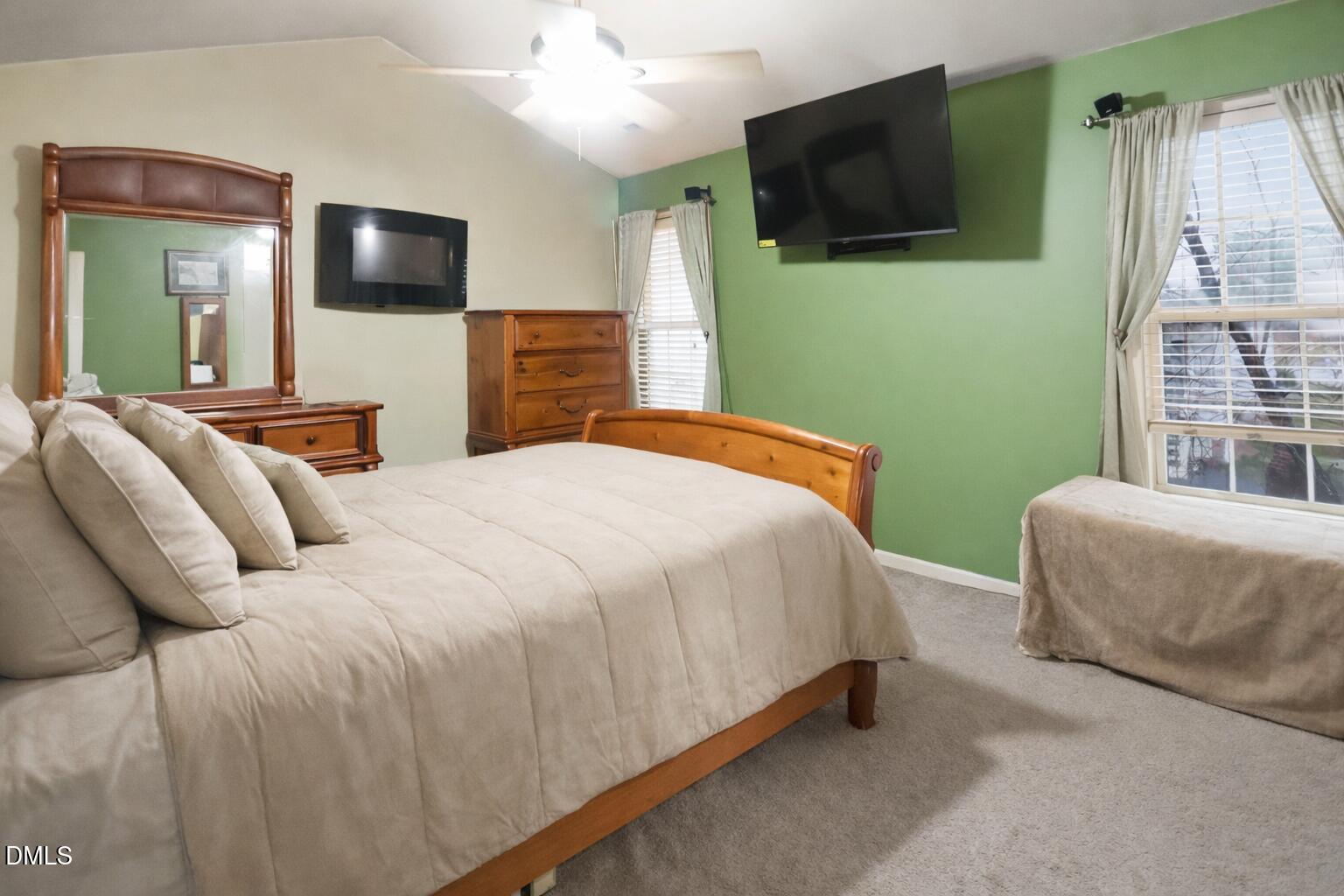 1504 Springshire Court Raleigh, NC 27610 - Photo 7 of 16 a bedroom with a bed and a flat screen tv
