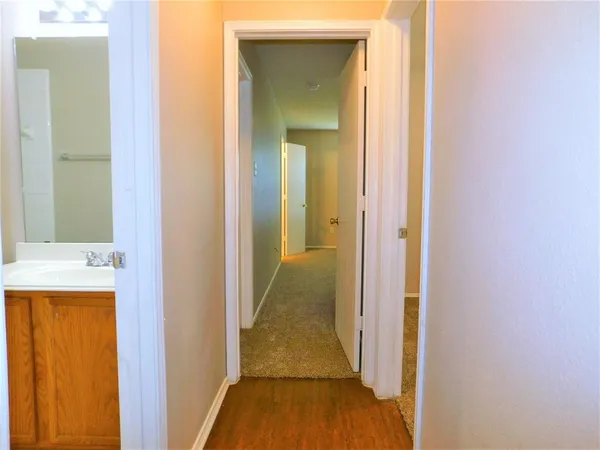 a view of a bathroom from a hallway