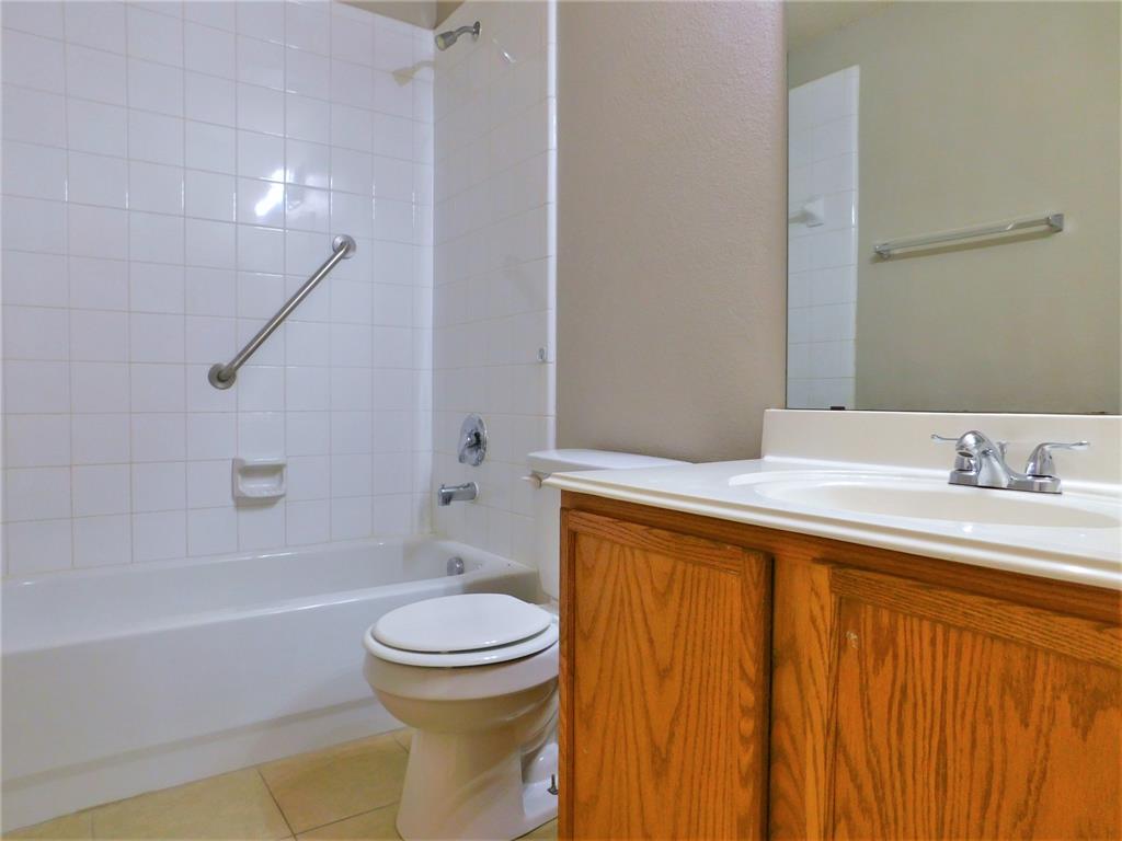 2408 Rolling Ridge Drive Little Elm, TX 75068 - Photo 13 of 25 a bathroom with a granite countertop sink toilet and shower