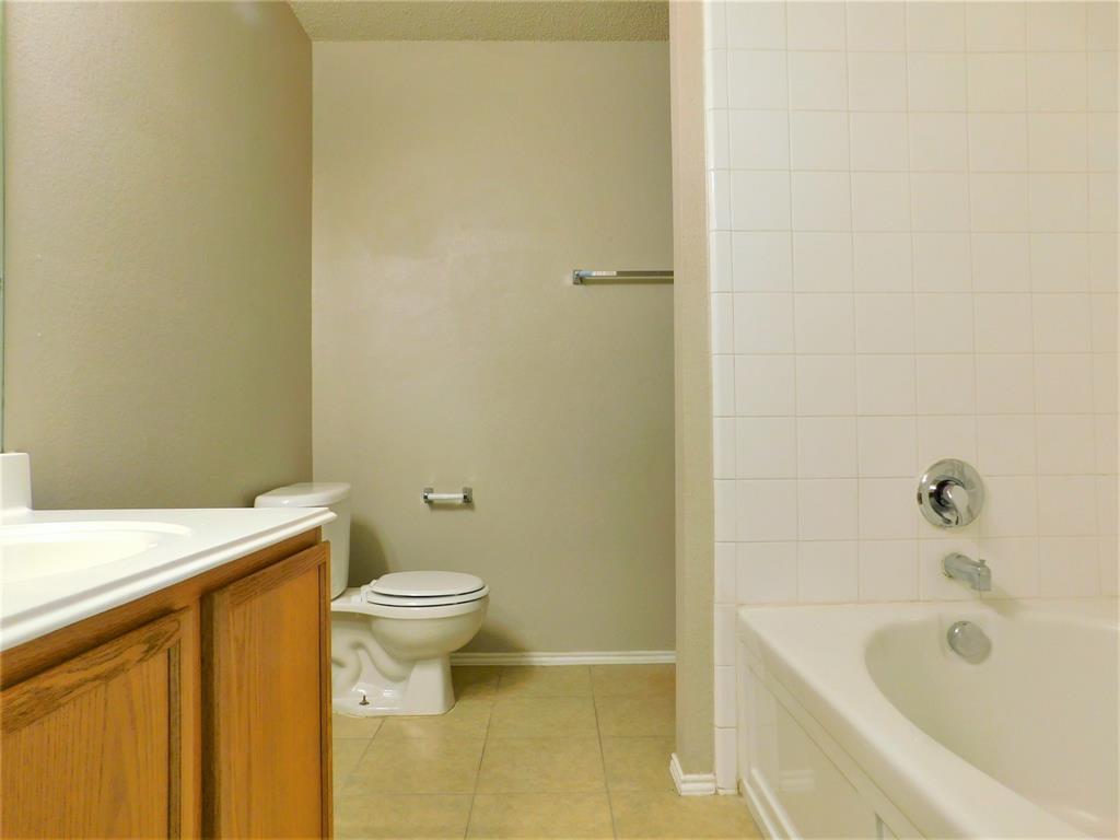 2408 Rolling Ridge Drive Little Elm, TX 75068 - Photo 20 of 25 a bathroom with a sink and a toilet