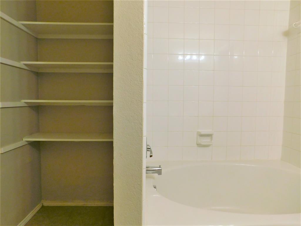 2408 Rolling Ridge Drive Little Elm, TX 75068 - Photo 21 of 25 a bathroom with a bathtub