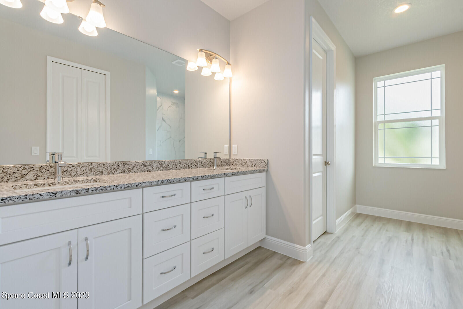 931 Thompson Road Southwest Palm Bay, FL 32908 - Photo 18 of 24 a bathroom with a granite countertop double vanity sink and mirror
