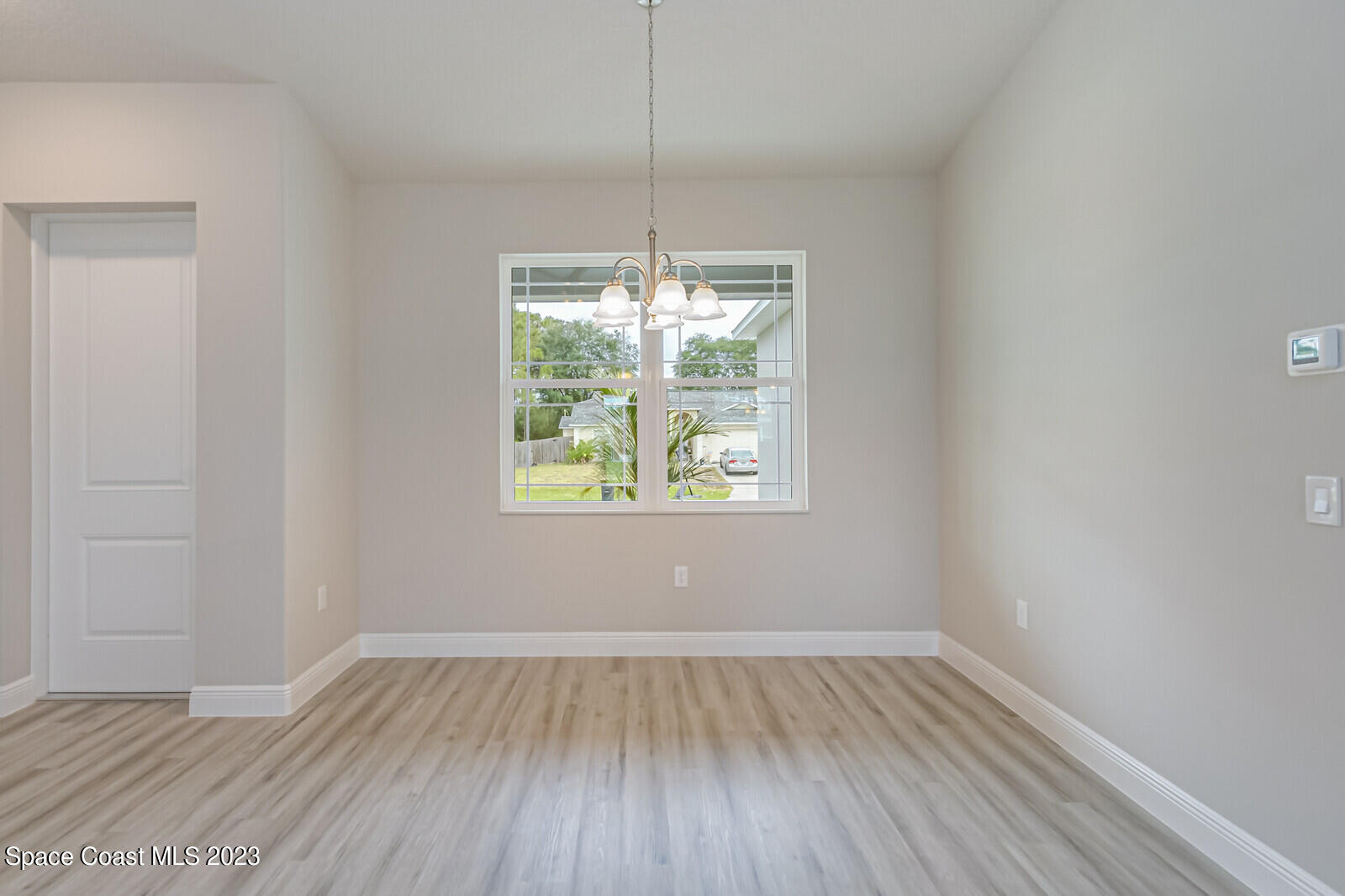 931 Thompson Road Southwest Palm Bay, FL 32908 - Photo 6 of 24 a view of room with window and wooden floor