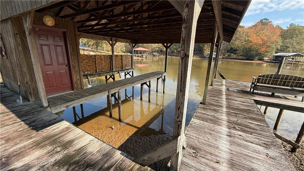 618 South Steel Bridge Road Eatonton, GA 31024 - Photo 11 of 20 a balcony with wooden floor stairs and furniture