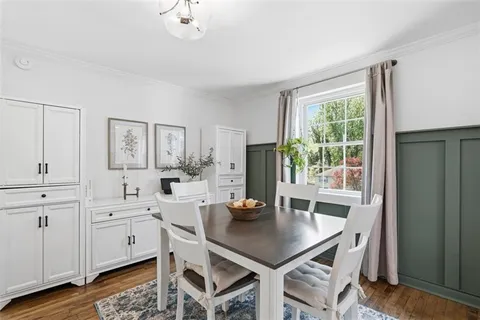 a view of a dining room with furniture and window