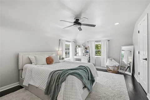 a bedroom with a large bed and a chandelier