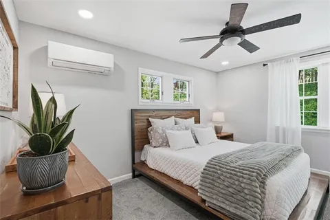 a bedroom with a bed and a potted plant