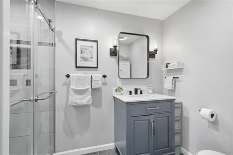 a bathroom with a toilet sink and mirror