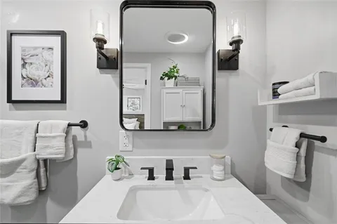 a bathroom with a sink and a mirror