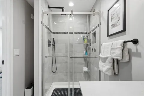 a bathroom with a glass shower door