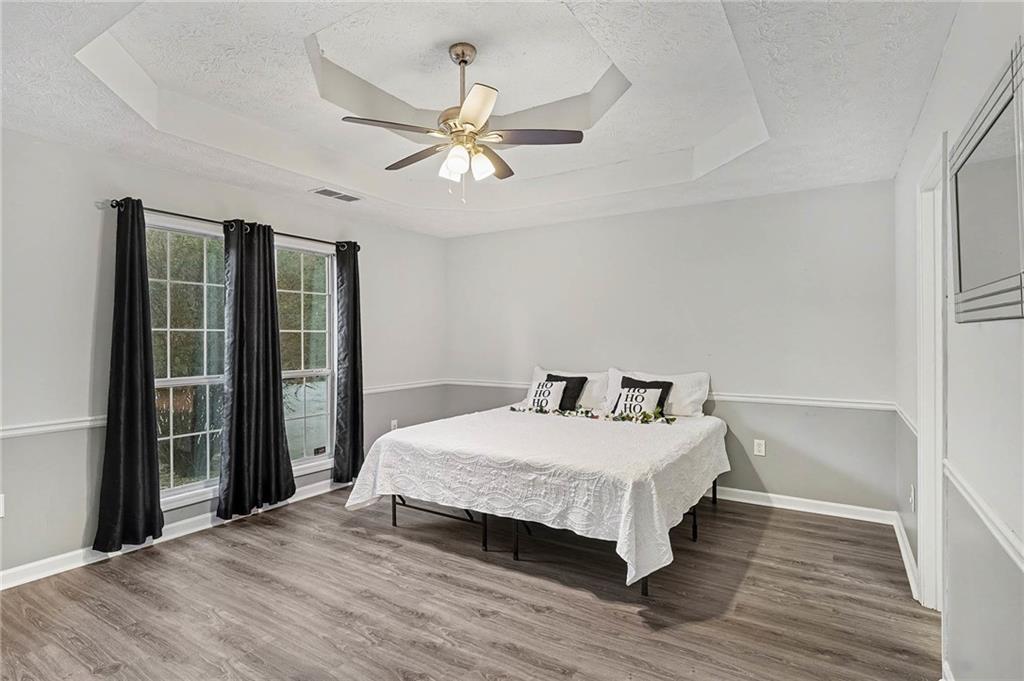 1752 Highway 162 Covington, GA 30016 - Photo 19 of 29 a bedroom with a large bed and a chandelier