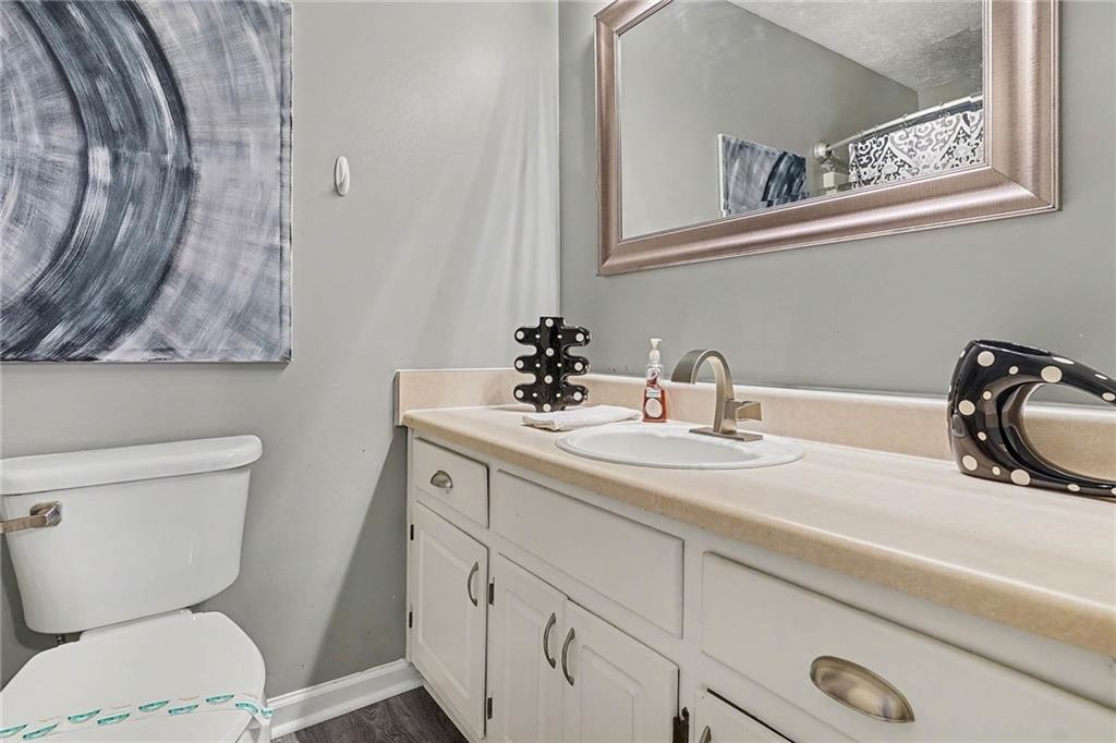 1752 Highway 162 Covington, GA 30016 - Photo 22 of 29 a bathroom with a toilet sink and mirror