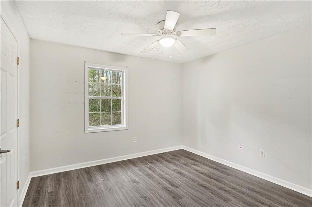 1752 Highway 162 Covington, GA 30016 - Photo 23 of 29 an empty room with wooden floor fan and windows