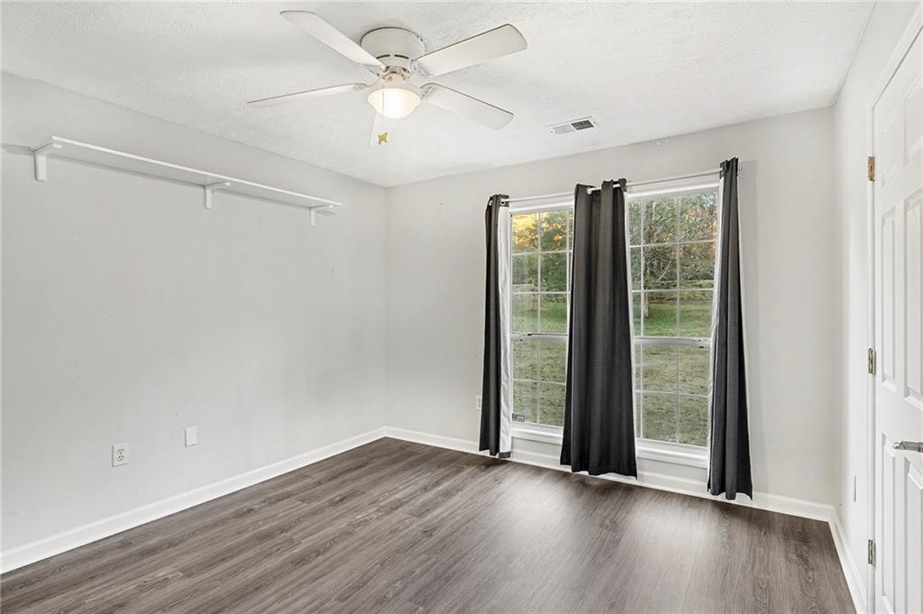 1752 Highway 162 Covington, GA 30016 - Photo 25 of 29 a view of an empty room with wooden floor and a window