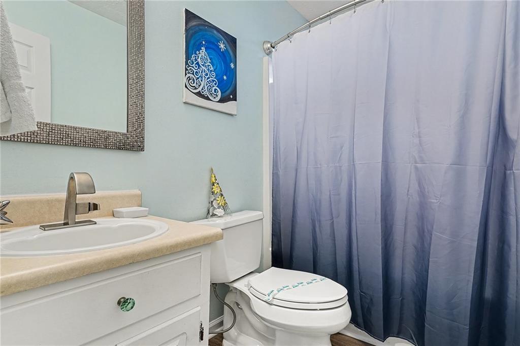 1752 Highway 162 Covington, GA 30016 - Photo 27 of 29 a bathroom with a sink a toilet and a mirror
