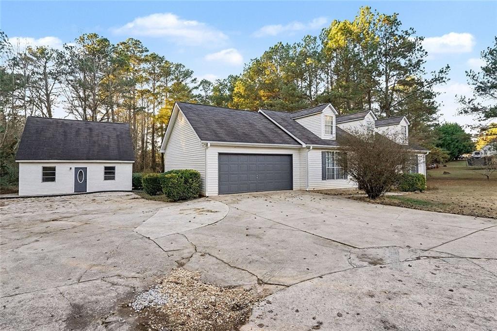 1752 Highway 162 Covington, GA 30016 - Photo 4 of 29 a front view of a house with a yard and garage