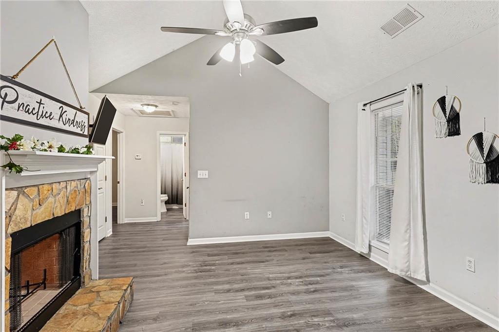 1752 Highway 162 Covington, GA 30016 - Photo 7 of 29 a view of an empty room with wooden floor fireplace and a window