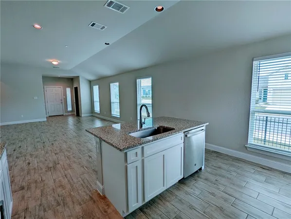 a kitchen with sink and mirror