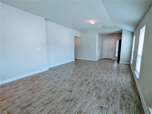 a view of hallway with wooden floor