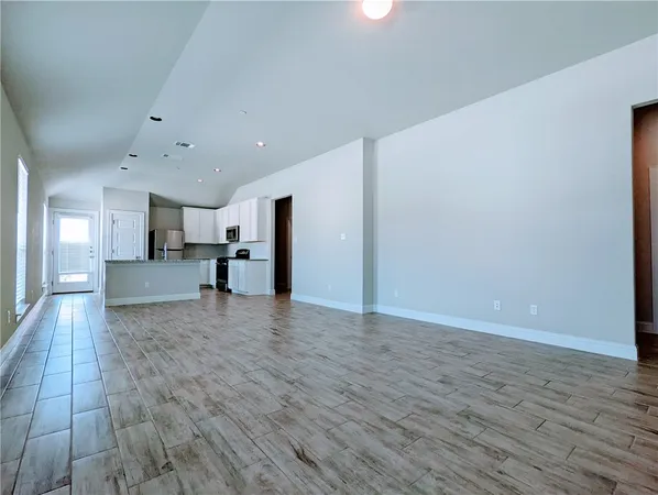 a view of a kitchen with wooden floor and a sink