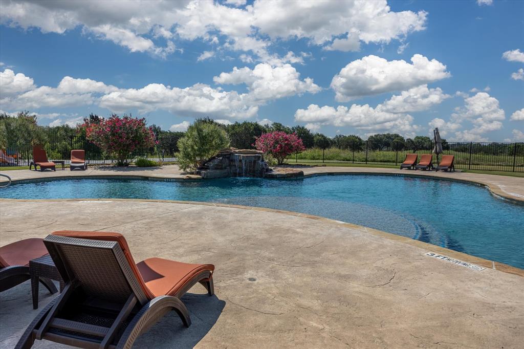 7308 Castle Royle Court Cleburne, TX 76033 - Photo 10 of 35 View of swimming pool featuring a patio and pool water feature