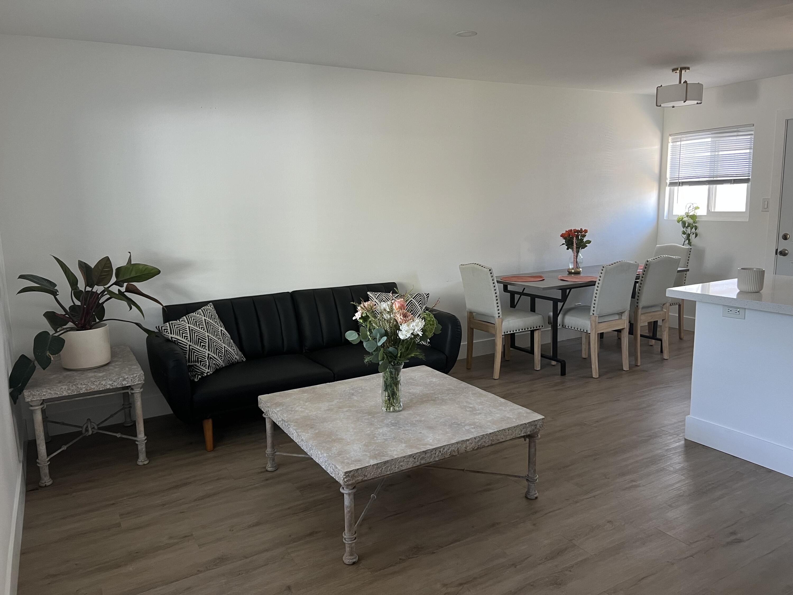 a living room with furniture a window and a table