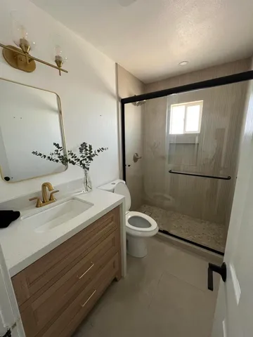 a bathroom with a sink toilet and shower