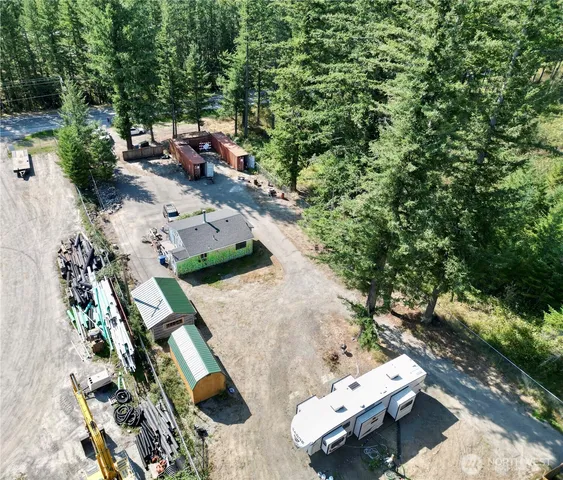 an aerial view of a house with a yard and lake view