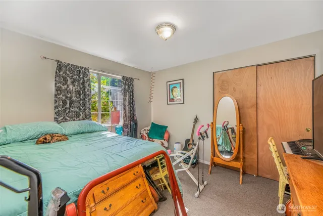 a bedroom with a large bed and a window