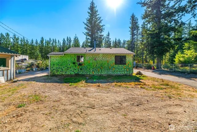 a view of a street with a house in the background