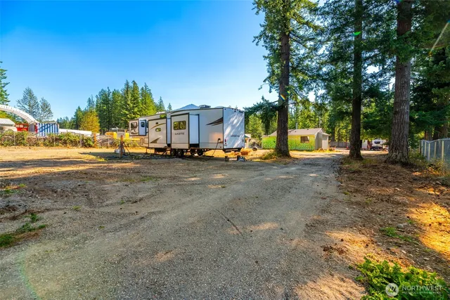 a view of a backyard with a table and chairs