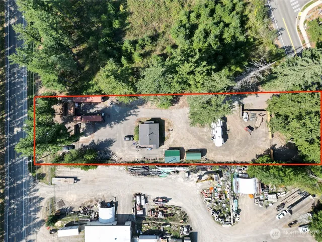 an aerial view of a house with a yard and lake view