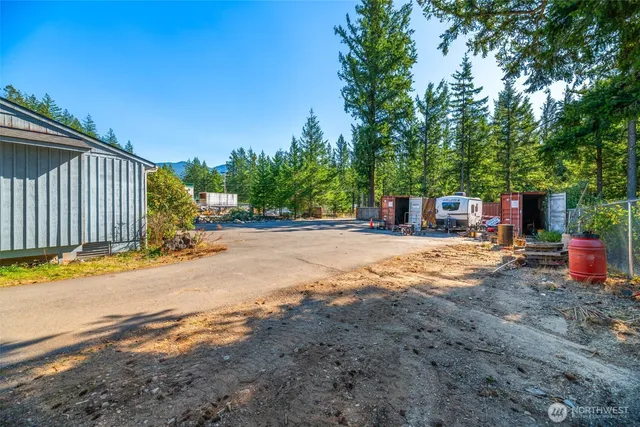 a view of a backyard with swimming pool
