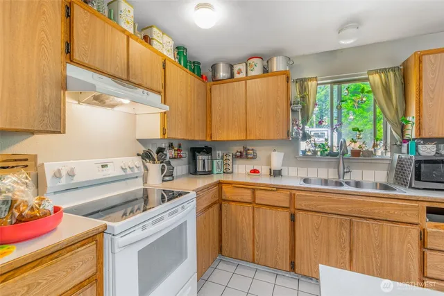 a kitchen that has a sink and a stove in it